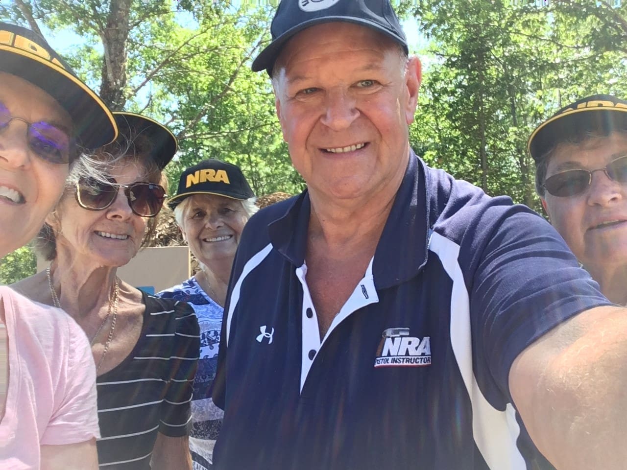 A man in a navy blue shirt and hat